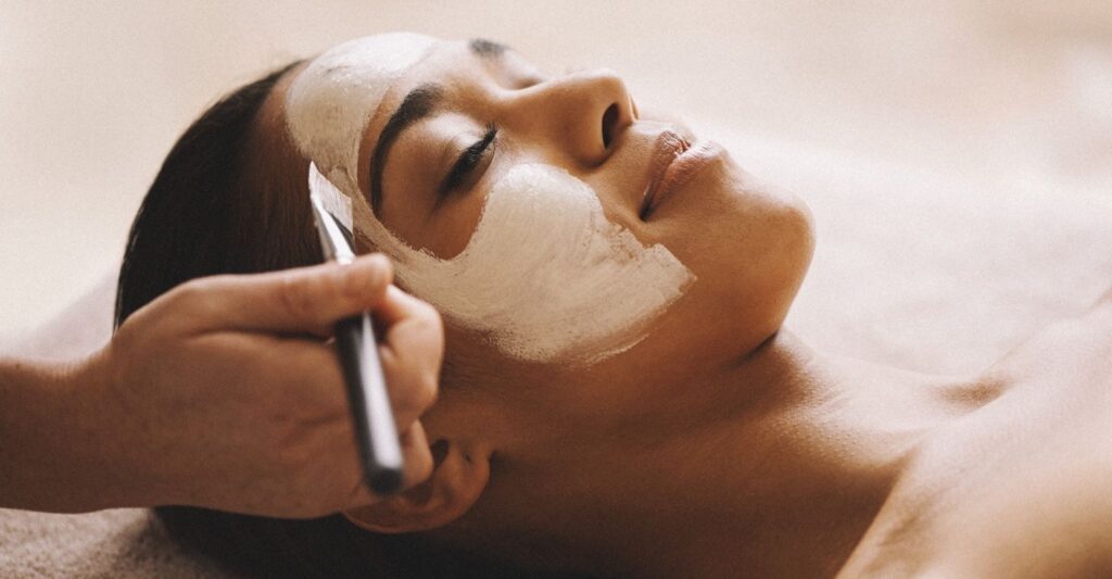 Woman receiving a soothing clay mask treatment at a spa offering Facial Services in Tysons Corner