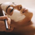 Woman receiving a soothing clay mask treatment at a spa offering Facial Services in Tysons Corner